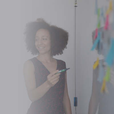 Woman is standing in front of the white board